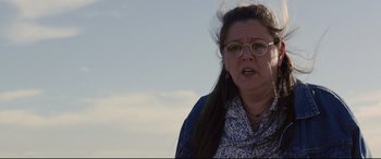 Movie still from “Cop Car” (2015), directed by Jon Watts – A person wearing glasses and a jacket; Close Up shot, Low angle