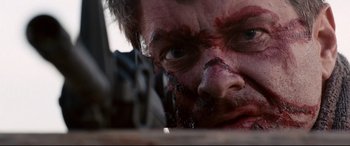 Movie still from “Cop Car” (2015), directed by Jon Watts – A man's face covered in blood; Extreme Close Up shot, Low angle