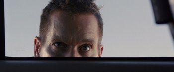 Movie still from “Cop Car” (2015), directed by Jon Watts – A person's eyes looking at the camera; Extreme Close Up shot, Low angle