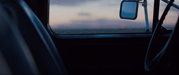 Movie still from “Cop Car” (2015), directed by Jon Watts – A view from inside a car looking out the window; Extreme Close Up shot, Over the shoulder angle