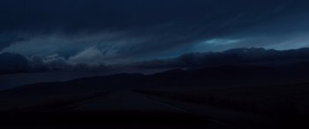 Movie still from “Cop Car” (2015), directed by Jon Watts – A dark sky with some clouds and a road; Extreme Wide shot, Low angle