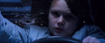 Movie still from “Cop Car” (2015), directed by Jon Watts – A young girl sitting in the driver's seat of a car; Close Up shot, High angle