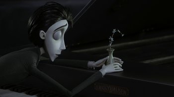 Movie still from “Corpse Bride” (2005), directed by Tim Burton – The head of a doll holding a vase of flowers; Medium shot, Over the shoulder angle