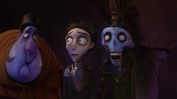 Movie still from “Corpse Bride” (2005), directed by Tim Burton – A couple of people standing next to each other in a dark room; Medium shot, Low angle
