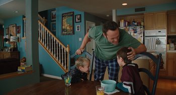 Movie still from “Couples Retreat” (2009), directed by Peter Billingsley – A man and two boys at a dining room table; Medium shot, Over the shoulder angle