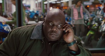 Movie still from “Couples Retreat” (2009), directed by Peter Billingsley – A bald man is talking on a cell phone; Close Up shot, High angle