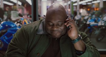 Movie still from “Couples Retreat” (2009), directed by Peter Billingsley – A person talking on a cell phone; Close Up shot, High angle