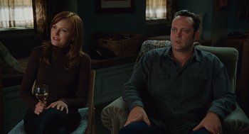 Movie still from “Couples Retreat” (2009), directed by Peter Billingsley – A man and a woman sitting in a living room; Medium shot, Over the shoulder angle