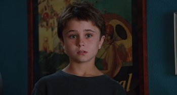 Movie still from “Couples Retreat” (2009), directed by Peter Billingsley – A young boy is looking into the camera; Close Up shot, Over the shoulder angle