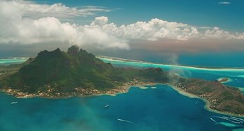 Movie still from “Couples Retreat” (2009), directed by Peter Billingsley – An aerial view of a body of water with a boat in it; Extreme Wide shot, High angle