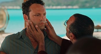 Movie still from “Couples Retreat” (2009), directed by Peter Billingsley – A man with glasses is touching the face of another man; Close Up shot, Over the shoulder angle