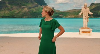 Movie still from “Couples Retreat” (2009), directed by Peter Billingsley – A woman standing on a beach wearing a green dress; Medium shot, Low angle