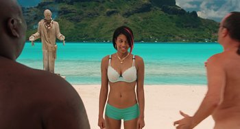 Movie still from “Couples Retreat” (2009), directed by Peter Billingsley – A beautiful young woman in a white and blue bikini; Medium shot, Over the shoulder angle