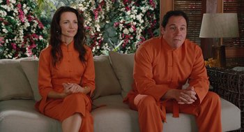 Movie still from “Couples Retreat” (2009), directed by Peter Billingsley – A man and a woman sitting next to each other on a couch; Medium shot, Over the shoulder angle