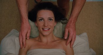 Movie still from “Couples Retreat” (2009), directed by Peter Billingsley – A woman is getting a massage from a masseur; Close Up shot, Overhead angle