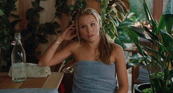 Movie still from “Couples Retreat” (2009), directed by Peter Billingsley – A beautiful young lady wrapped in a blue towel; Medium shot, Over the shoulder angle