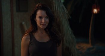 Movie still from “Couples Retreat” (2009), directed by Peter Billingsley – A beautiful young lady standing in front of a tree; Close Up shot, Over the shoulder angle