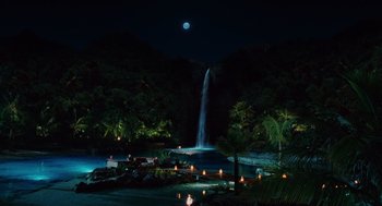 Movie still from “Couples Retreat” (2009), directed by Peter Billingsley – A night scene of a waterfall with a moon in the background; Extreme Wide shot, High angle