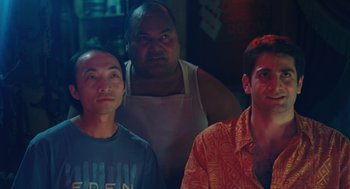 Movie still from “Couples Retreat” (2009), directed by Peter Billingsley – A group of men standing next to each other in a room; Medium shot, Over the shoulder angle