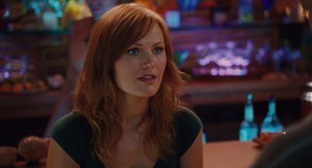 Movie still from “Couples Retreat” (2009), directed by Peter Billingsley – A woman with red hair sitting at a table; Close Up shot, Over the shoulder angle
