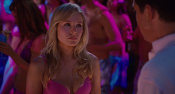 Movie still from “Couples Retreat” (2009), directed by Peter Billingsley – A woman in a pink bathing suit looking to her left; Close Up shot, Over the shoulder angle