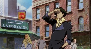 Movie still from “Cowboy Bebop: The Movie” (2001), directed by Yoshiyuki Takei – An animated man standing in front of a brick building; Medium shot, Low angle
