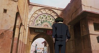 Movie still from “Cowboy Bebop: The Movie” (2001), directed by Yoshiyuki Takei – A man standing in front of an archway; Wide shot, Low angle