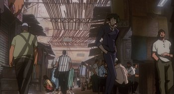 Movie still from “Cowboy Bebop: The Movie” (2001), directed by Yoshiyuki Takei – An animated scene of a man standing in a crowded area; Wide shot, Low angle
