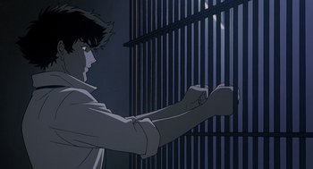Movie still from “Cowboy Bebop: The Movie” (2001), directed by Yoshiyuki Takei – A man standing in front of a metal fence; Medium shot, Low angle