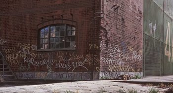 Movie still from “Cowboy Bebop: The Movie” (2001), directed by Yoshiyuki Takei – A brick building with graffiti on the side of the building; Wide shot, Low angle