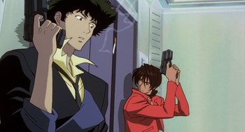 Movie still from “Cowboy Bebop: The Movie” (2001), directed by Yoshiyuki Takei – A man holding a gun while standing next to another man; Medium shot, Low angle