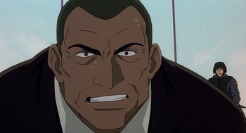 Movie still from “Cowboy Bebop: The Movie” (2001), directed by Yoshiyuki Takei – An animated face of a man in a black suit; Close Up shot, Low angle
