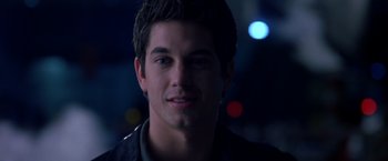 Movie still from “Coyote Ugly” (2000), directed by David McNally – A young man is smiling for the camera; Close Up shot, Over the shoulder angle