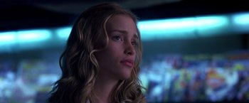 Movie still from “Coyote Ugly” (2000), directed by David McNally – A girl with long blonde curly hair looking to her left; Close Up shot, Low angle