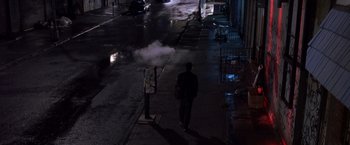Movie still from “Coyote Ugly” (2000), directed by David McNally – A man walking down a street at night; Extreme Wide shot, High angle