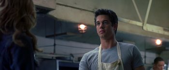 Movie still from “Coyote Ugly” (2000), directed by David McNally – A man wearing an apron looking to his left; Close Up shot, Low angle