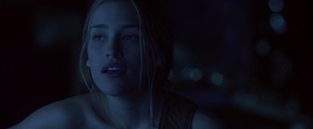 Movie still from “Coyote Ugly” (2000), directed by David McNally – A young woman with blue eyes is looking at the camera; Close Up shot, Over the shoulder angle