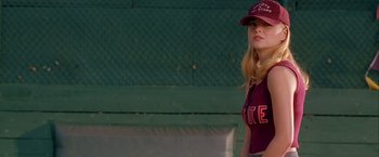 Movie still from “Coyote Ugly” (2000), directed by David McNally – A woman wearing a baseball uniform and a hat; Medium shot, Over the shoulder angle