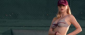Movie still from “Coyote Ugly” (2000), directed by David McNally – A beautiful young lady wearing a bikini top and baseball cap; Medium shot, Low angle