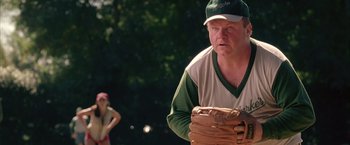 Movie still from “Coyote Ugly” (2000), directed by David McNally – A man in a baseball uniform holding a catchers mitt; Medium shot, Over the shoulder angle