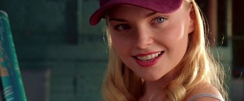 Movie still from “Coyote Ugly” (2000), directed by David McNally – A person wearing a hat; Close Up shot, Over the shoulder angle