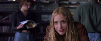Movie still from “Coyote Ugly” (2000), directed by David McNally – A beautiful young lady with long blonde hair and green eyes; Close Up shot, Over the shoulder angle
