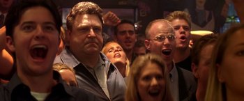 Movie still from “Coyote Ugly” (2000), directed by David McNally – A group of men and women standing in front of a crowd; Close Up shot, Low angle