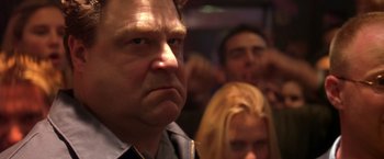 Movie still from “Coyote Ugly” (2000), directed by David McNally – A person with a crowd in the background; Close Up shot, Low angle