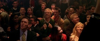 Movie still from “Coyote Ugly” (2000), directed by David McNally – A group of people sitting in a room with drinks; Medium shot, High angle