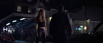 Movie still from “Coyote Ugly” (2000), directed by David McNally – A man and a woman standing next to each other in the dark; Medium shot, Over the shoulder angle