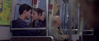 Movie still from “Coyote Ugly” (2000), directed by David McNally – A man and a woman kissing on a train; Medium shot, Over the shoulder angle