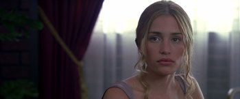 Movie still from “Coyote Ugly” (2000), directed by David McNally – A beautiful young woman looking at the camera; Close Up shot, Over the shoulder angle