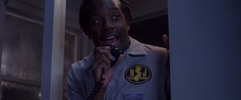 Movie still from “Coyote Ugly” (2000), directed by David McNally – A man holding a phone up to his ear; Close Up shot, Low angle