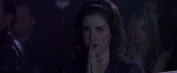 Movie still from “Coyote Ugly” (2000), directed by David McNally – A woman with her hands over her mouth; Close Up shot, Over the shoulder angle